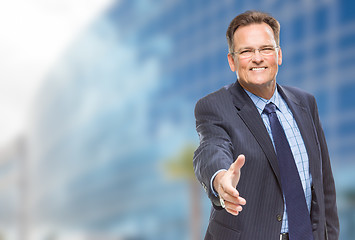 Image showing Businessman Reaching for Hand Shake in Front of Building