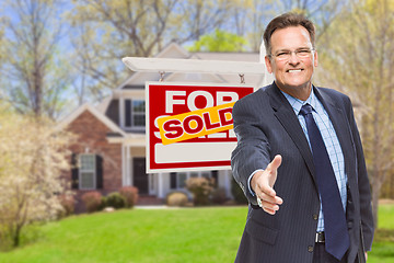 Image showing Male Agent Reaching for Hand Shake in Front of House and Sold Re