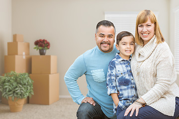 Image showing Mixed Race Family with Son in Room with Packed Moving Boxes