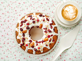 Image showing freshly baked fruit cake and cup of cappuccino coffee