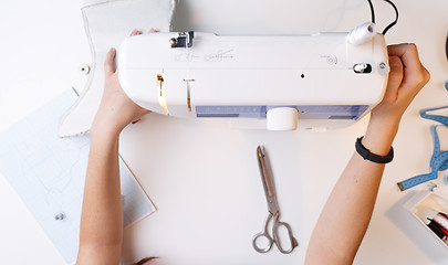 Image showing Girl with sewing-machine top view