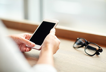 Image showing close up of woman texting on smartphone