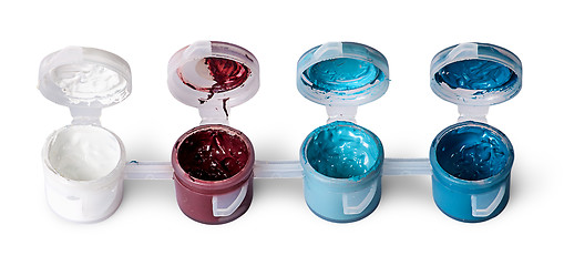 Image showing Few colored acrylic paints in open jars