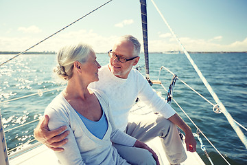 Image showing senior couple hugging on sail boat or yacht in sea