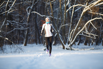 Image showing Sportswoman on jogging in winter