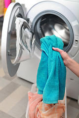 Image showing woman loading clothes in washing machine