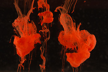 Image showing Red paint drops in the water