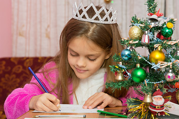 Image showing A girl waiting for a new year, writes a letter to the desires