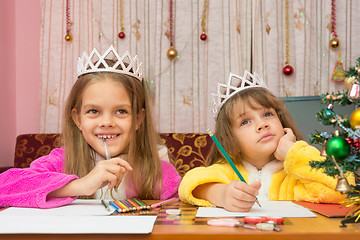 Image showing Two girls make a wish for the new year