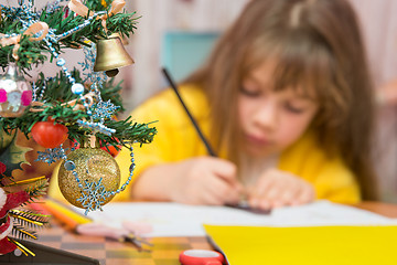 Image showing Carried away by a girl making Christmas crafts, focusing on the fur-tree