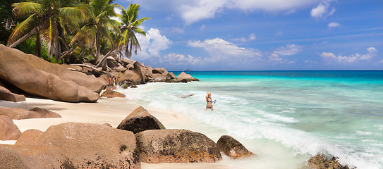 Image showing Woman enjoying Anse Patates picture perfect beach on La Digue Island, Seychelles.