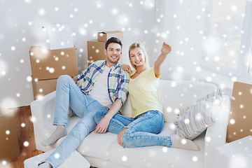 Image showing couple with boxes moving to new home and dreaming