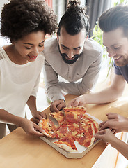 Image showing happy business team eating pizza in office