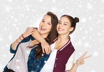 Image showing happy teenage girls hugging and showing peace sign