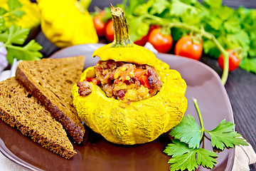 Image showing Squash yellow stuffed with meat and vegetables on dark board