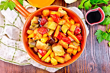 Image showing Roast with vegetables and honey in pan on board top