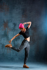 Image showing Young girl break dancing on wall background.