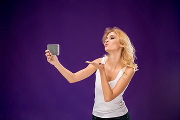 Image showing Portrait of beautiful smiling girl with modern l phone