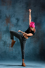 Image showing Young girl break dancing on wall background.