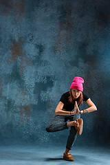 Image showing Young girl break dancing on wall background.