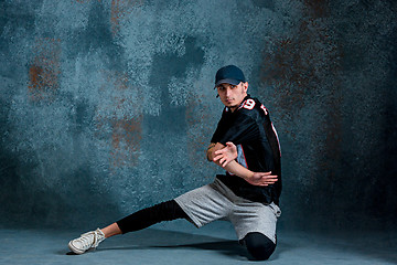 Image showing Young man break dancing on wall background.