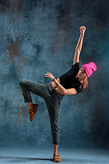 Image showing Young girl break dancing on wall background.