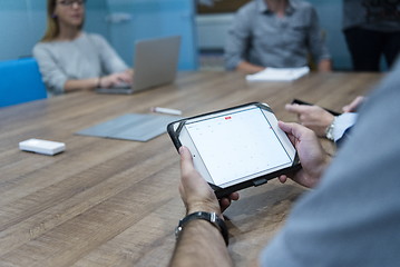 Image showing close up of businessman on meeting using tablet