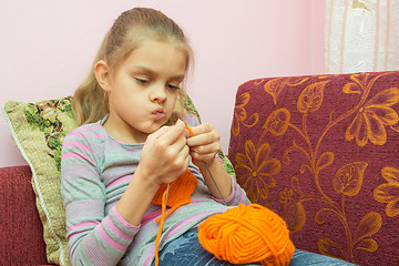 Image showing The girl thought doing Knitting