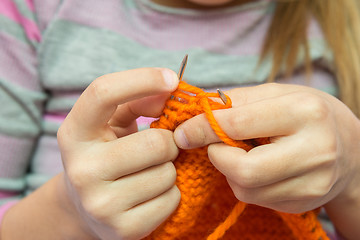 Image showing Close-up of children hands to knit with needles