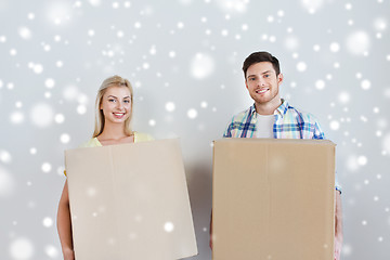 Image showing smiling couple with big boxes moving to new home