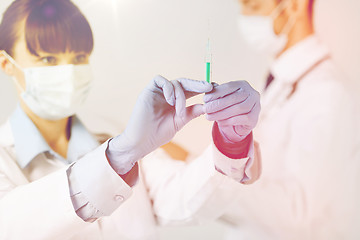 Image showing doctors with syringe