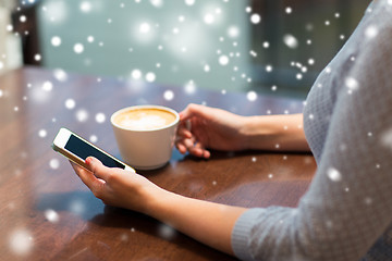 Image showing woman with smartphone drinking coffee at cafe