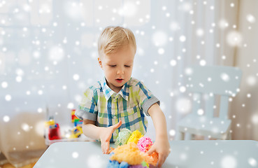 Image showing happy little baby boy with ball clay at home