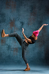 Image showing Young girl break dancing on wall background.