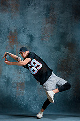 Image showing Young man break dancing on wall background.