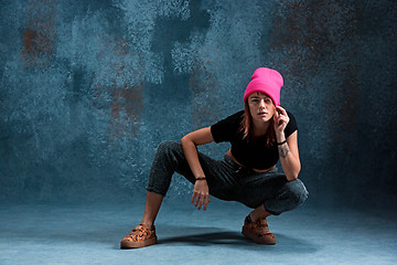 Image showing Young girl break dancing on wall background.