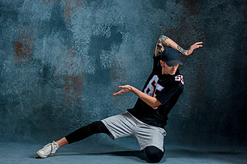 Image showing Young man break dancing on wall background.