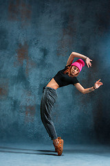 Image showing Young girl break dancing on wall background.