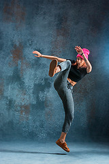 Image showing Young girl break dancing on wall background.