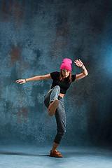 Image showing Young girl break dancing on wall background.