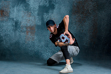 Image showing Young man break dancing on wall background.