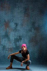 Image showing Young girl break dancing on wall background.