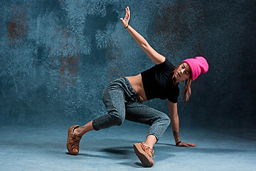 Image showing Young girl break dancing on wall background.