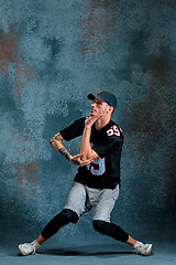 Image showing Young man break dancing on wall background.