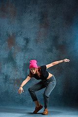 Image showing Young girl break dancing on wall background.