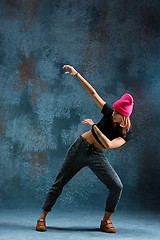 Image showing Young girl break dancing on wall background.