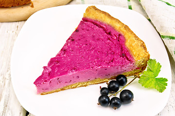 Image showing Pie of black currants in plate on board