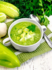 Image showing Soup cucumber with parsley in white bowl on light board