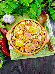 Image showing Rice with chicken and zucchini in bowl on board top