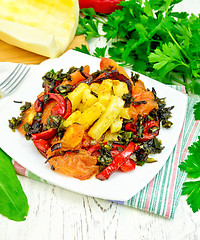 Image showing Courgettes with vegetables in plate on towel